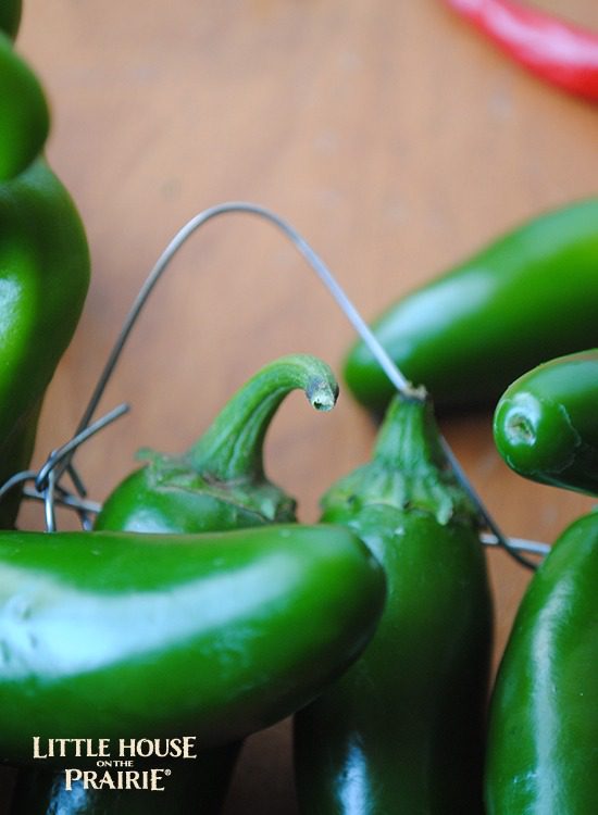 Stringing the peppers along the wire wreath