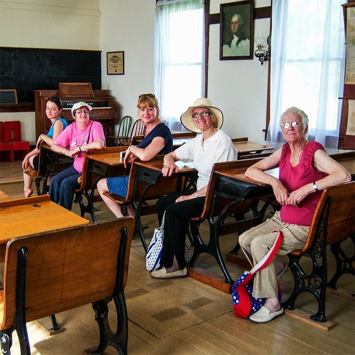 Tour group from the UK in Schoolhouse at Independence, KS site.