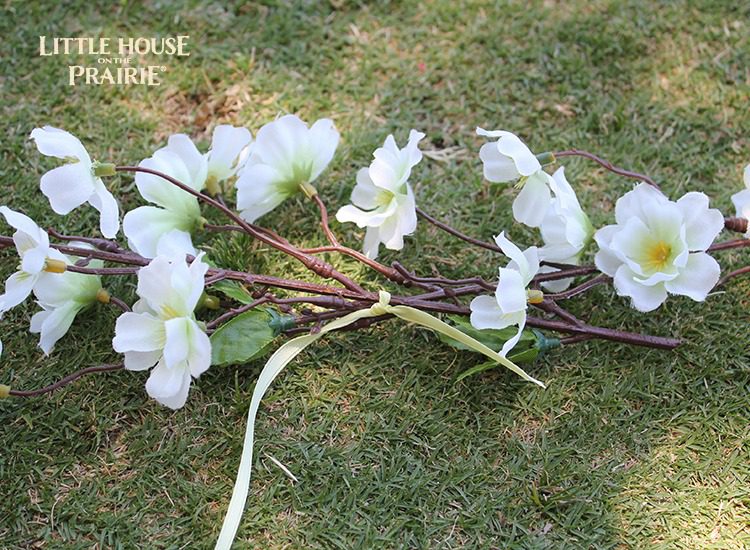 Securing the flower stems to form the basis of the flower hair wreath.