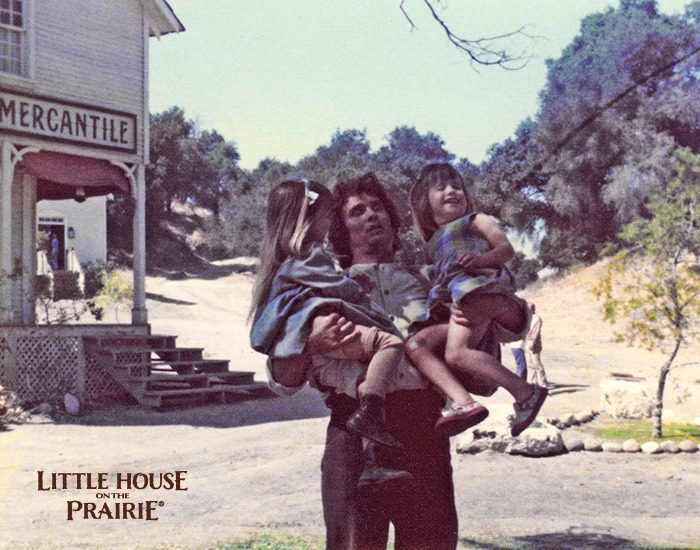 Michael Landon carrying the Greenbush twins on the set of Little House on the Prairie